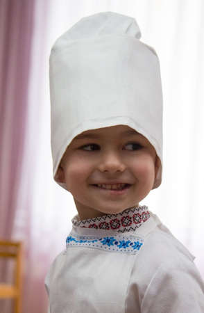 LUTSK, UKRAINE - MARCH 02 - Boy dressed in chef during 8 March event in nursery school  in Lutsk on March 02, 2016. Shallow depth of field.のeditorial素材
