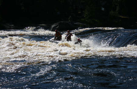 KOLSKYY, RUSSIA - 17 August 2008: Team of men on an inflatable catamaran at rough river.のeditorial素材