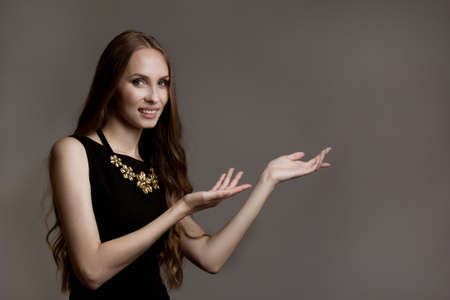 Caucasian young woman with long hair gesturing with handsの写真素材