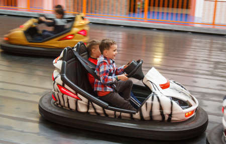 LUTSK, UKRAINE - 16 April 2016: Children having fun driving electric toy car