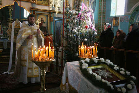 VOYUTYN, UKRAINE - 08 JANUARY 2009: Orthodox priest during Christmas serviceのeditorial素材