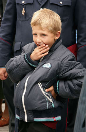 ZHURAVYCHI, UKRAINE - 12 September 2008: A boy yawns during the Ceremonial opening of temporary residence of foreigners and stateless persons who illegally stay in Ukraineのeditorial素材