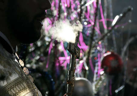 VOYUTYN, UKRAINE - 08 JANUARY 2009: Steam from mouth of orthodox priest during Christmas serviceのeditorial素材