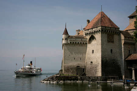 MONTREUX, SWITZERLAND - 03 May 2009: Scenic panorama view of traditional paddle steamer excursion ship with historic Chateau de Chillon at famous Lake Geneva on a sunny day in summer, Canton of Vaudのeditorial素材