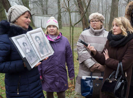 KACHANIVKA, UKRAINE - 25 November 2016: Female journalists with recorders interviewing local ethnographerのeditorial素材