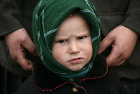 RIVNE, UKRAINE - 04 NOVEMBER 2008 - Poor child stand near mother in a home after fire. Shallow depth of field.のeditorial素材