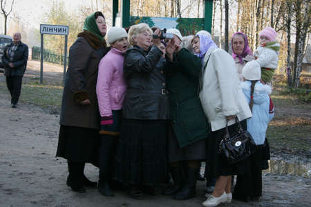 LINCHYN, UKRAINE - 21 October 2008: Woman filmed on camera tree which was a religious signのeditorial素材