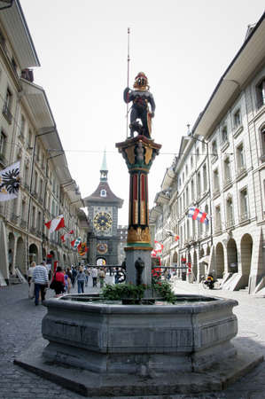 BERN, SWITZERLAND - 03 May 2009: Statue in front of clock towerのeditorial素材