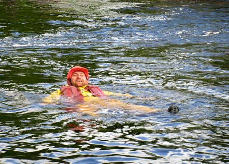 KOLSKY, RUSSIA - 17 AUGUST 2008: Man in life jacket and helmet posing in mountain riverのeditorial素材
