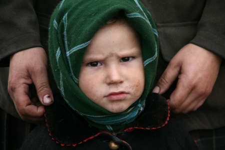 RIVNE, UKRAINE - 04 NOVEMBER 2008 - Poor little boy stand near mother in a home after fire. Shallow depth of field.のeditorial素材