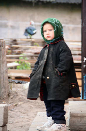 RIVNE, UKRAINE - 04 NOVEMBER 2008 - Poor little boy stand near home after fireのeditorial素材