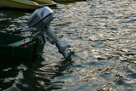 BOREMEL, UKRAINE - 26 June 2008: Outboard engine on the old wooden boat at lakeのeditorial素材