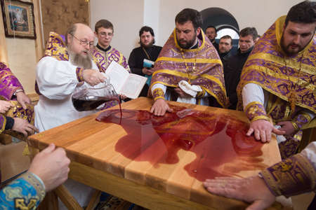 VOYUTYN, UKRAINE - 11 March 2017: Orthodox priests consecrated wine in new throne altarのeditorial素材