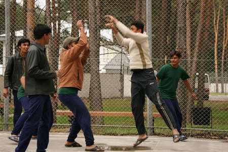 ZHURAVYCHI, UKRAINE - 12 September 2008: Men playing basketball in the temporary residence of...