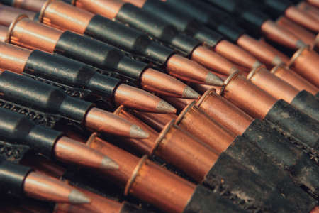Bullets in ammunition belt for machine gun. Shallow depth of field.の写真素材