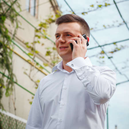 VILHIVKA, UKRAINE - 21 May 2017: Unknown handsome man cell phone call outdoorのeditorial素材