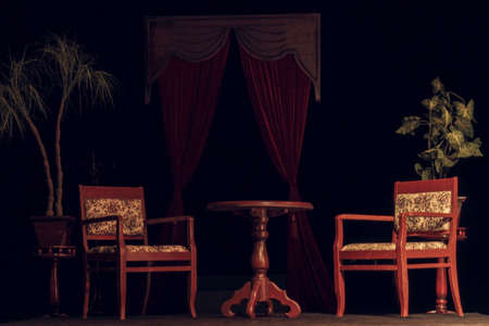 Old wooden round table and two chairsの写真素材