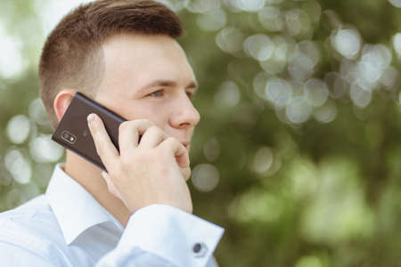 VILHIVKA, UKRAINE - 21 May 2017: Unknown handsome man cell phone call outdoorのeditorial素材