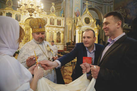 LUTSK, UKRAINE - 26 March 2017: The ceremony of christening the little girl at churchのeditorial素材