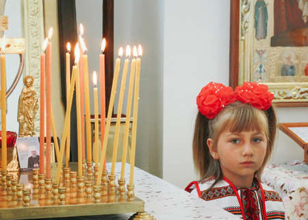 VOYUTYN, UKRAINE - 23 August 2015: Little ukrainian girl posing in Orthodox Churchのeditorial素材