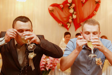 GOLOBY, UKRAINE - 20 September 2015: Two men drinking alcohol at restaurant during weddingのeditorial素材