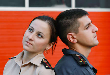 Young man and woman in ukrainian costume officers of the Ukrainian Ministry of Emergency Situationsの写真素材