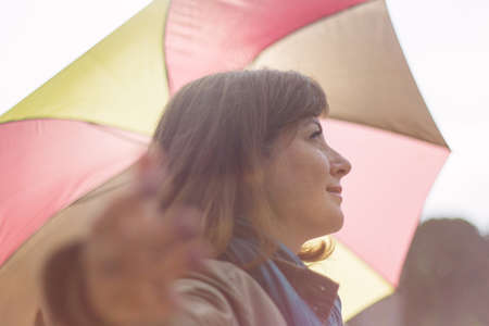 Girl with an umbrella in the rays of a sunの写真素材