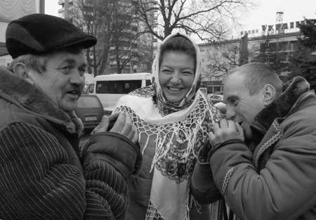 LUTSK, UKRAINE - 11 January 2009: Three people at Christmas market on Teatralna Squareのeditorial素材