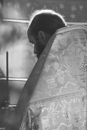 VOYUTYN, UKRAINE - 14 October 2008: Orthodox priest during holiday prayers in local churchのeditorial素材