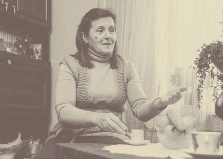 PAVLIVKA, UKRAINE - 19 December 2008: Woman reading fortune with cup of coffee at homeのeditorial素材