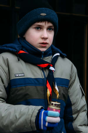 LUTSK, UKRAINE - 04 January 2009: Boy scout with lamp during a meeting of the Bethlehem fire
