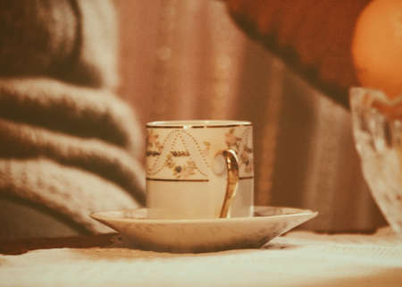 Cup of coffee on table in room, vintage or retro color toned. Shallow depth of field.の写真素材