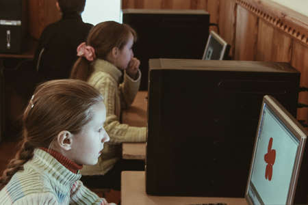 STARA, UKRAINE - 23 December 2008: Female elementary school children in computer classのeditorial素材