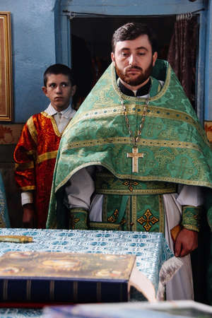 VOYUTYN, UKRAINE - 14 OCTOBER 2008: Orthodox priest and sexton during celebration Pokrovのeditorial素材