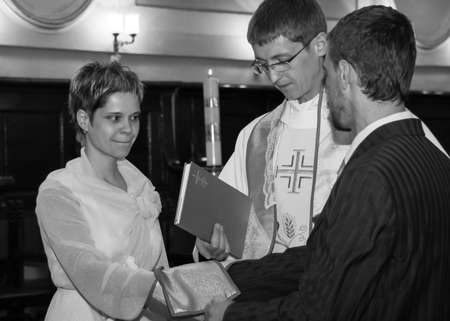 LUTSK, UKRAINE - 26 July 2009: Wedding couple swear one to one at christian churchのeditorial素材