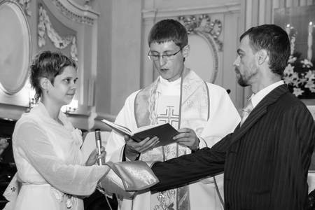 LUTSK, UKRAINE - 26 July 2009: Wedding couple swear one to one at christian churchのeditorial素材