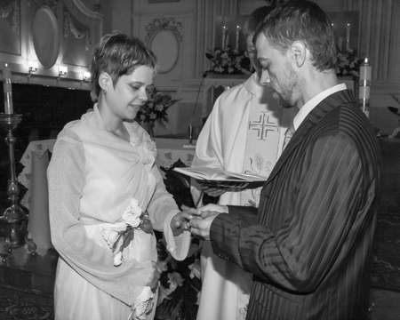 LUTSK, UKRAINE - 26 July 2009: Wedding couple swear one to one at christian churchのeditorial素材