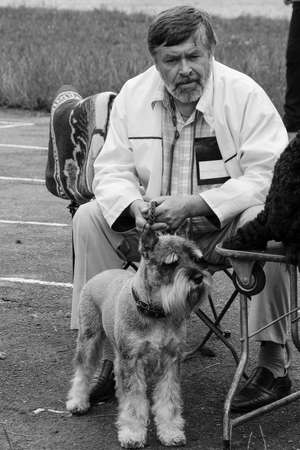 LUTSK, UKRAINE - 20 June 2009: Unknown man and his dog (terrier) at park in summerのeditorial素材