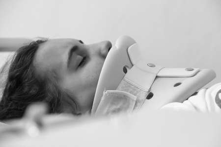 KOVEL, UKRAINE - 11 July 2013: Young woman after car crash with a neck brace in bed at hospitalのeditorial素材