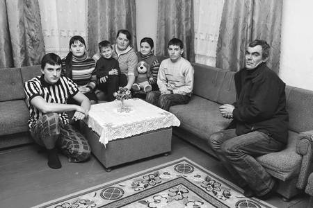 POLYCI, UKRAINE - 27 January 2009: Unhappy Family Sitting On Sofa. Father is alone.のeditorial素材