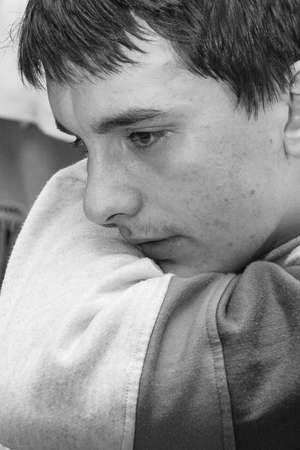 POLYCI, UKRAINE - 27 January 2009: Teenager boy with tears in eyes and sad expression at homeのeditorial素材