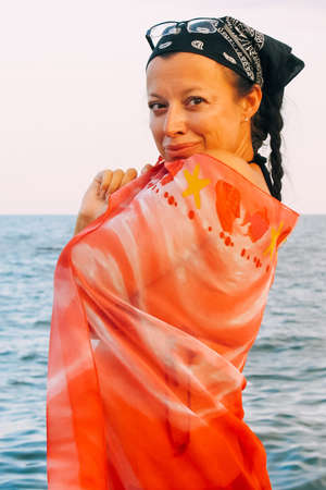 Caucasian woman at the beach with pareoの写真素材