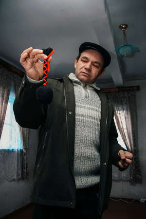 RIVNE, UKRAINE - 3 February 2009: Man with pendulum at homeのeditorial素材