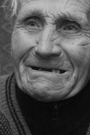 CHERVONOGRAD, UKRAINE - 28 January 2009: Old man face with ugly teeth at homeのeditorial素材