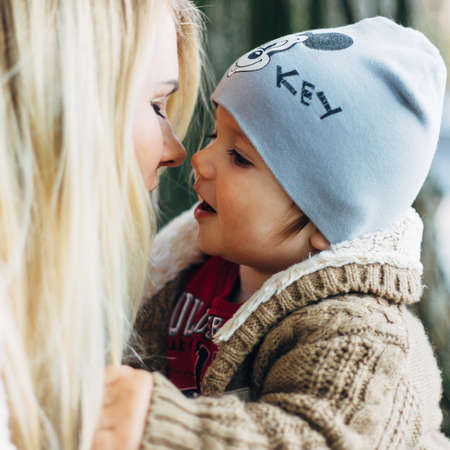 LUTSK, UKRAINE - 19 October 2017: Young unknown mother with her little baby boy having fun in the autumn park. Shallow depth of field.のeditorial素材