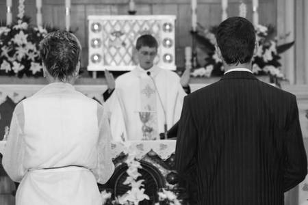 LUTSK, UKRAINE - 26 July 2009: Couple getting married at christian church. Shallow depth of field.のeditorial素材