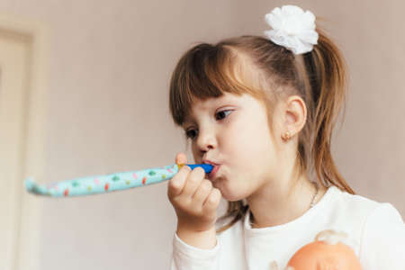 Little girl with pigtails birthday party at home. Shallow depth of field.の写真素材