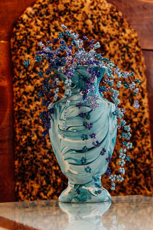 Bead flowers in vase on table