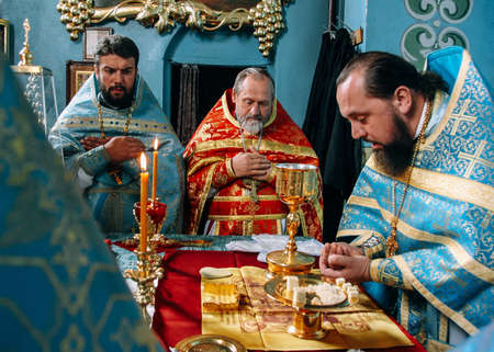 LUTSK, Volyn / UKRAINE - October 14 2009: Priest consecrates bread during orthodox liturgy ceremonyのeditorial素材