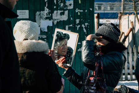 Zabolottia, Volyn / Ukraine - January 20 2009: Women choosing winter hat at local marketのeditorial素材